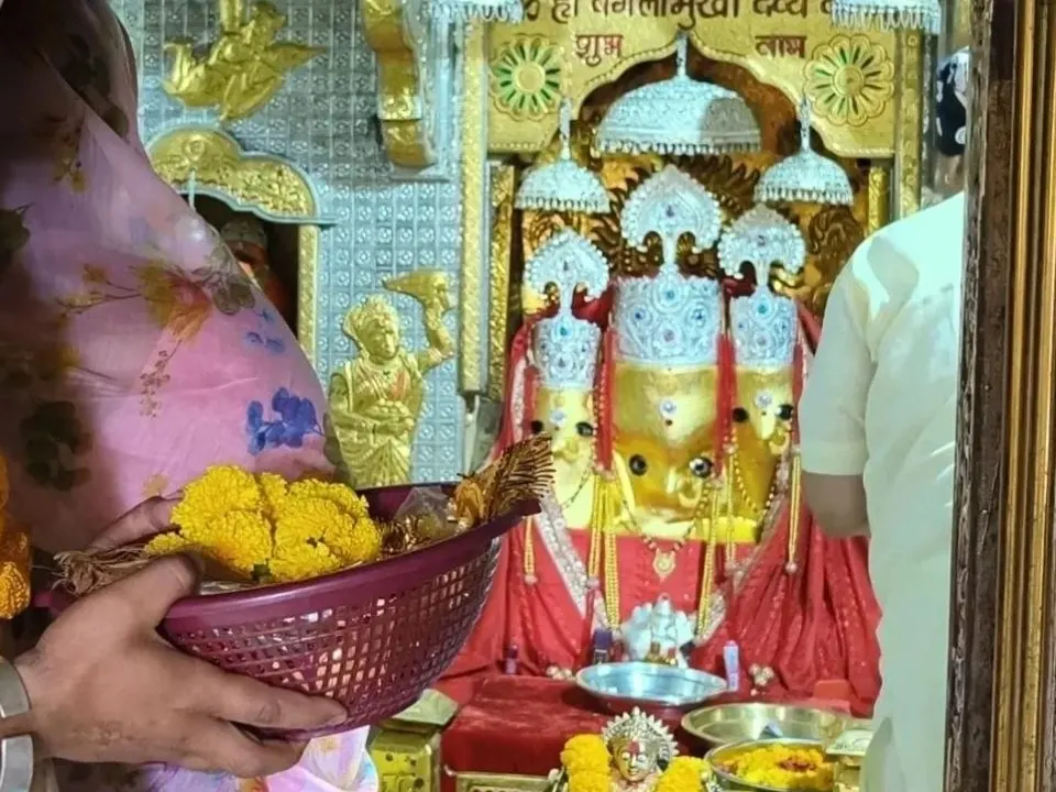 Marigold offering before Maa Baglamukhi in the sanctum of Maa Baglamukhi Temple, Nalkheda